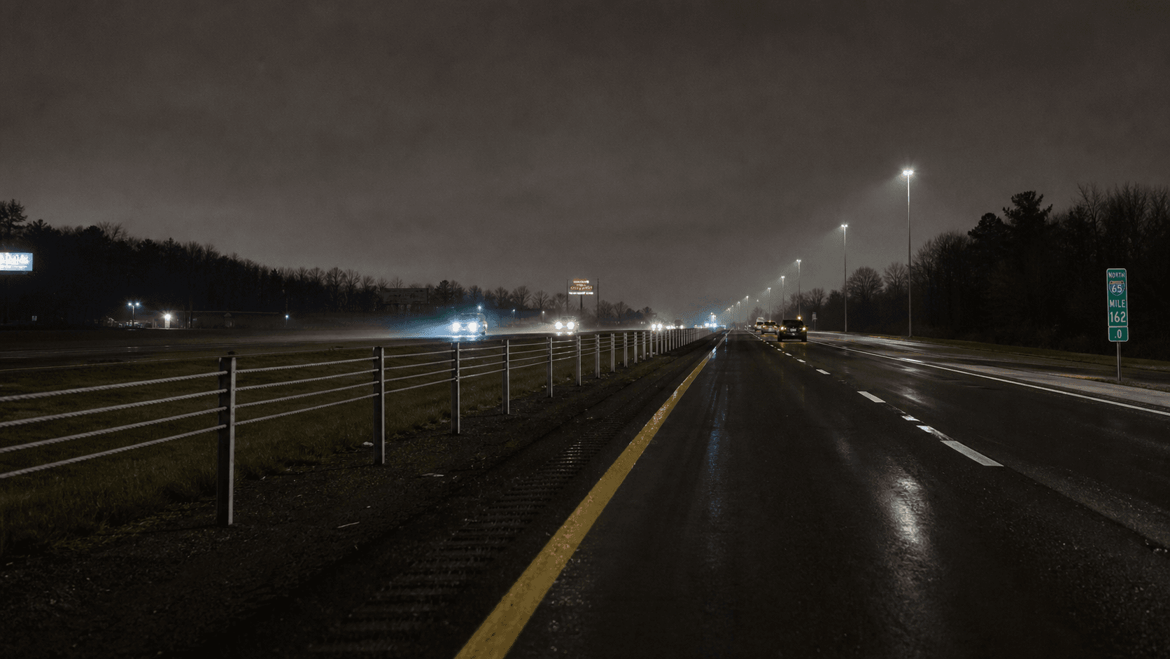 Northbound Interstate 69 at night with cable median barrier near the GM Fort Wayne Assembly Plant in Allen County, Indiana, the corridor where the fatal motorcycle crash occurred.