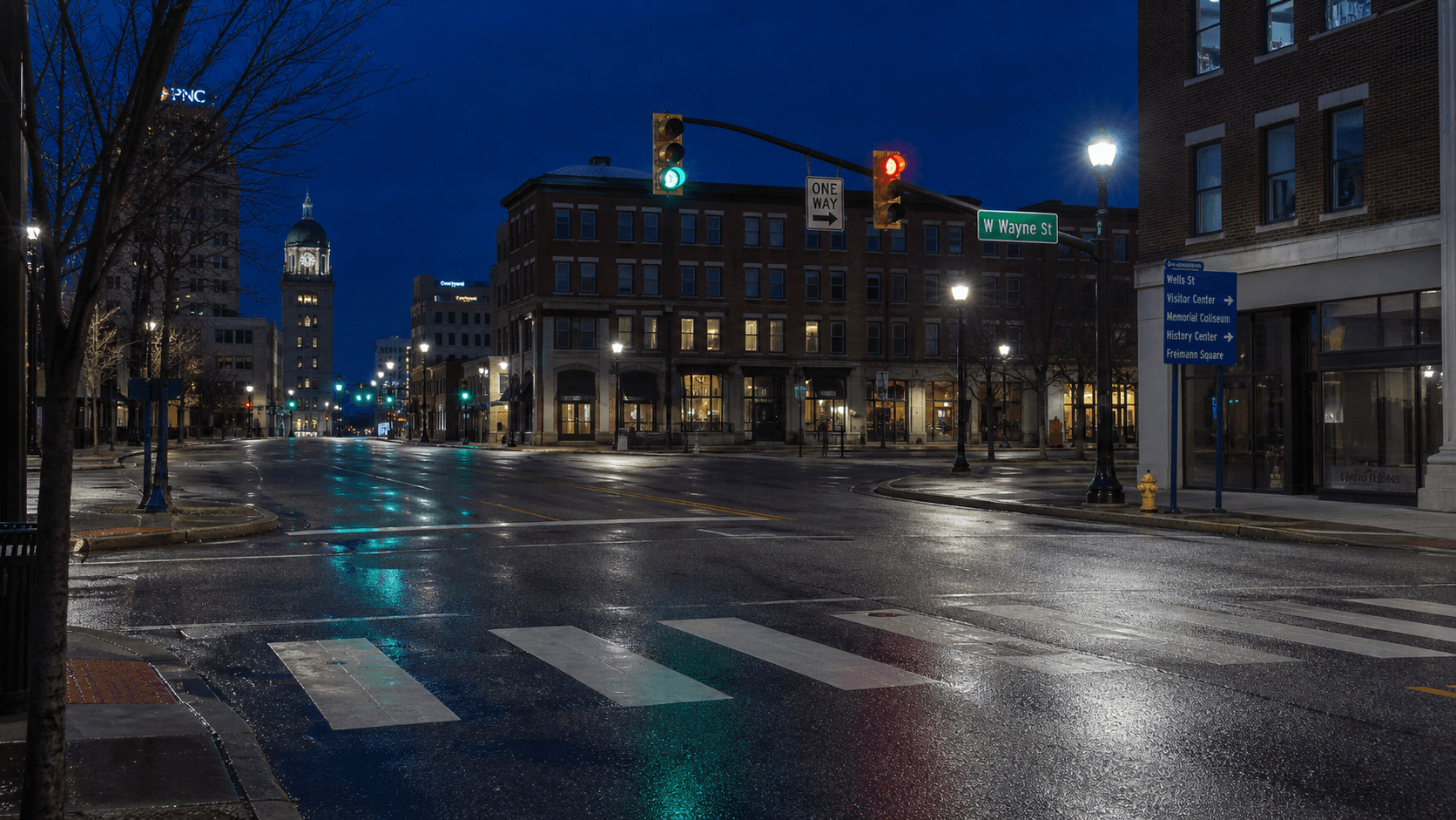 Nighttime view of a downtown Fort Wayne, Indiana crosswalk and traffic signal near the South Lafayette Street and East Washington Boulevard intersection where a pedestrian was critically injured