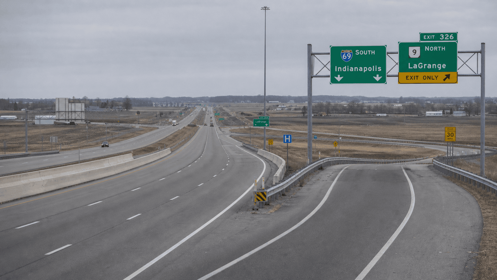 Wide view of the US-30 and I-469 highway interchange in western Allen County, Indiana, where a semi-truck and passenger car crash seriously injured one person