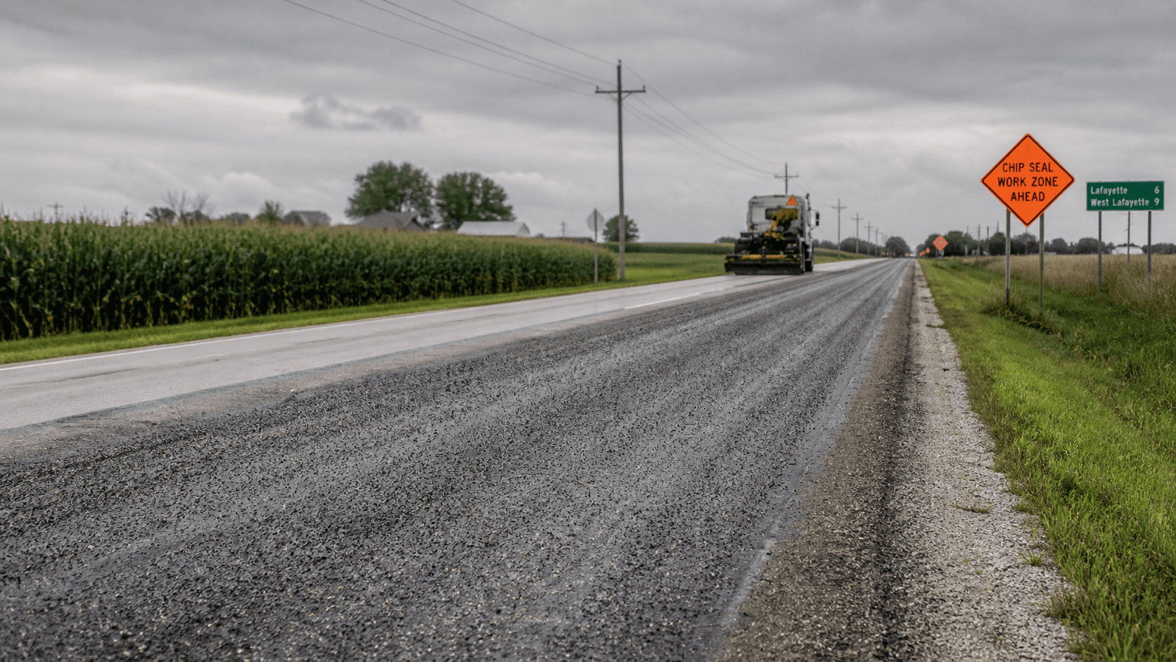 Active chip-and-seal work zone on a rural state highway near Lafayette in Tippecanoe County, illustrating the setting of the State Road 28 motorcycle crash.