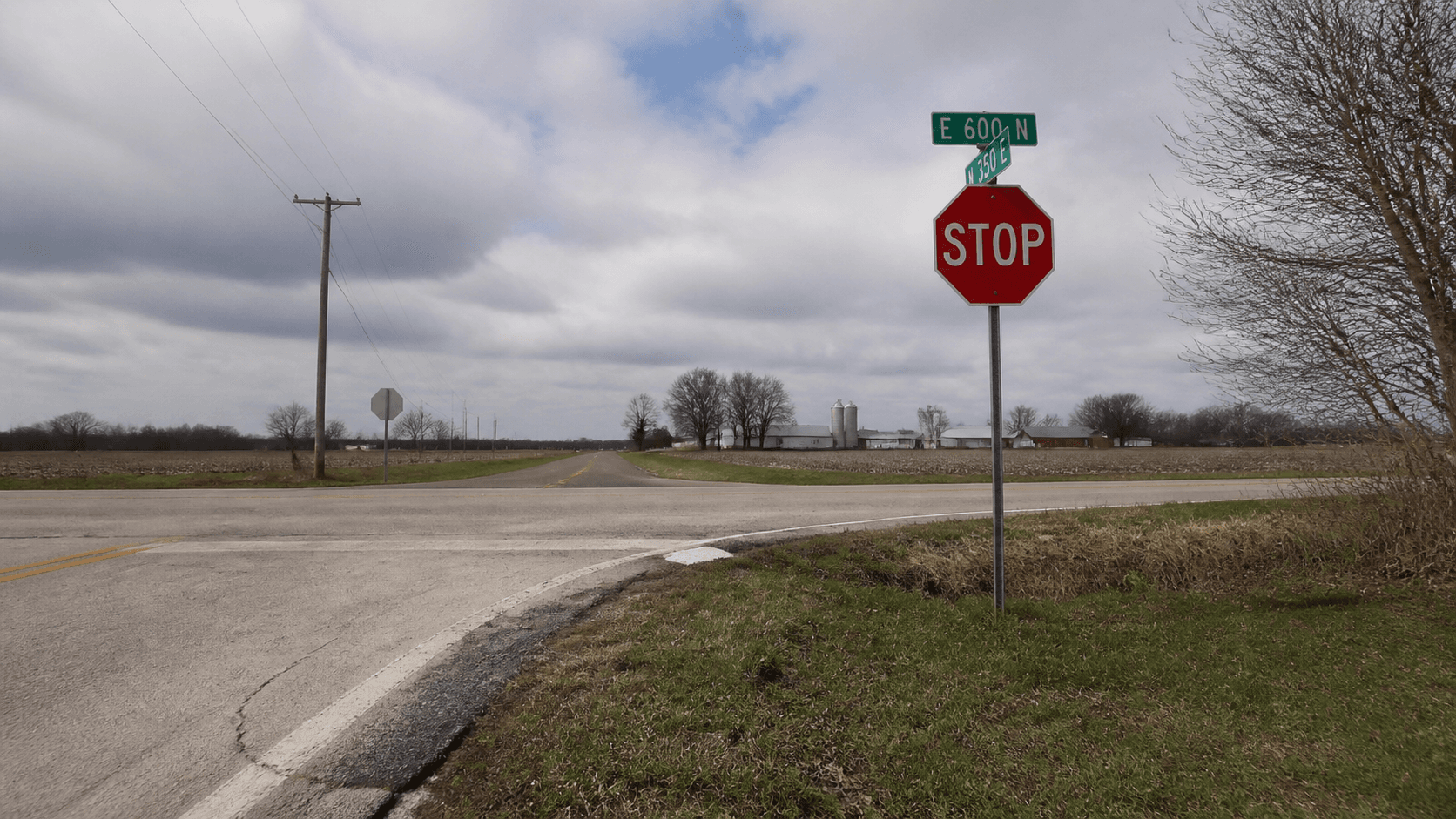 Rural intersection with a stop sign near Remington in White County, representing the County Road 1100 West and Division Road crash investigation.
