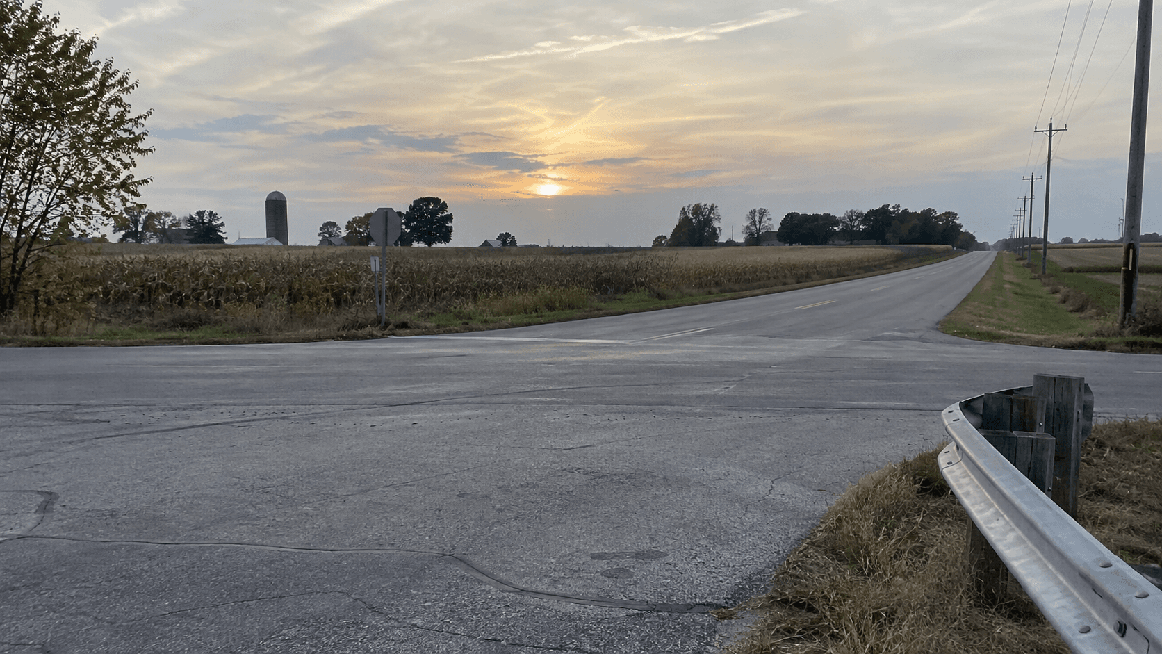 Rural county-road intersection and guardrail in LaPorte County, representing the reported single-vehicle crash near County Road 400 South and County Road 800 East.