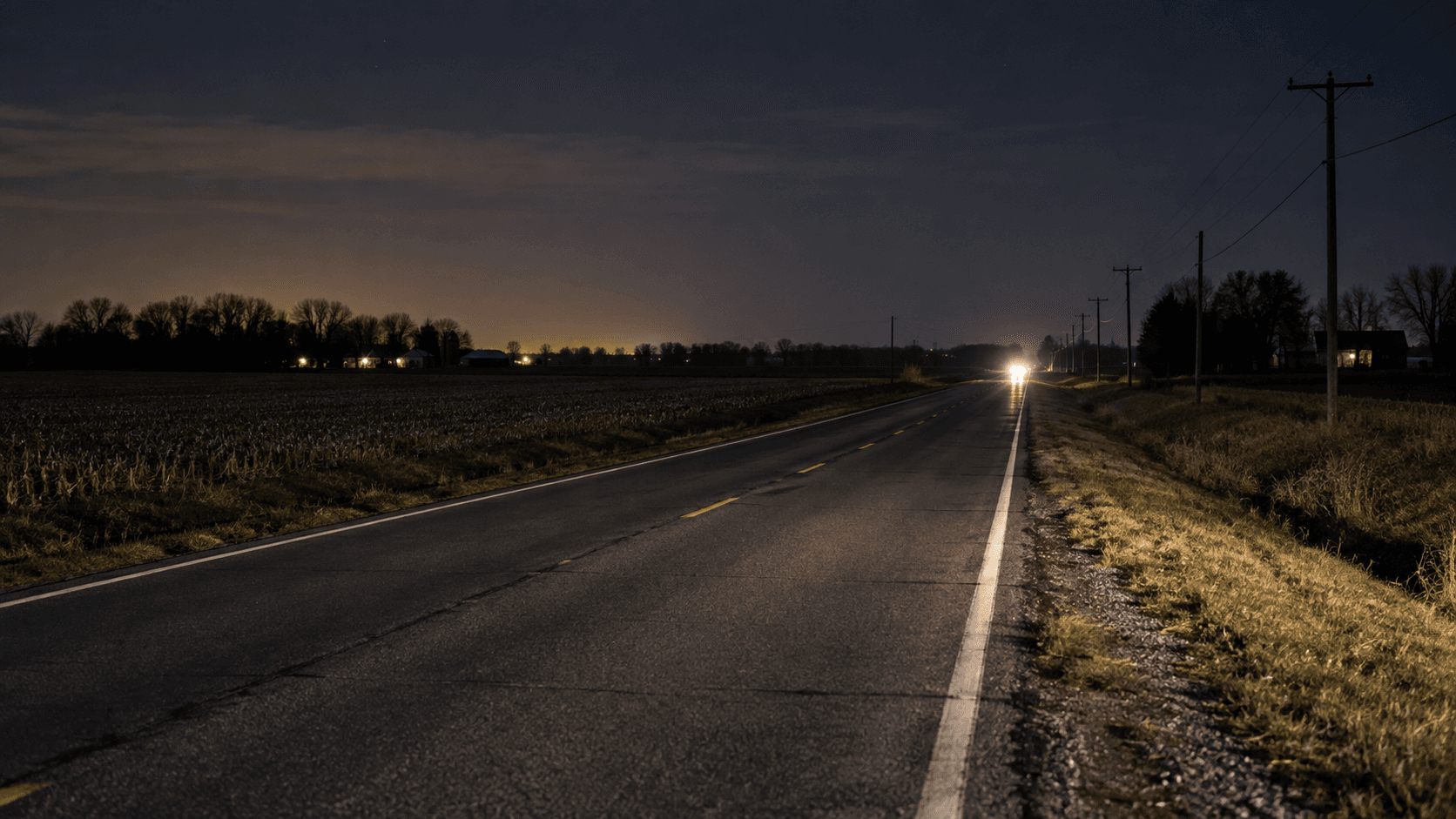 Nighttime view of a two-lane county road near Plymouth in Marshall County, illustrating the setting of the reported 9A Road distracted-driving rollover.