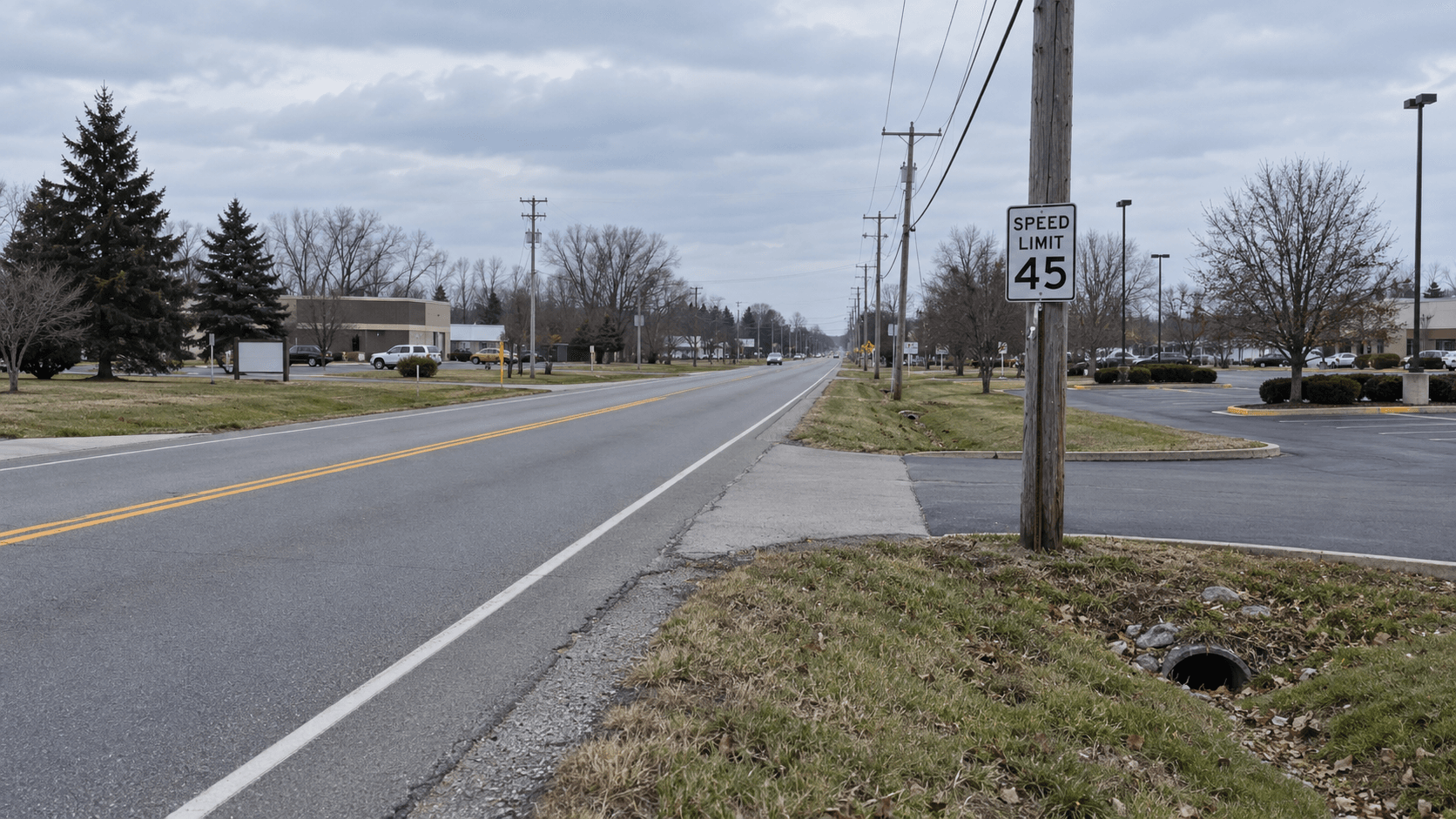 County Road 20 near a parking-lot entrance in Elkhart County, where a reported left-turn failure-to-yield crash injured a driver.