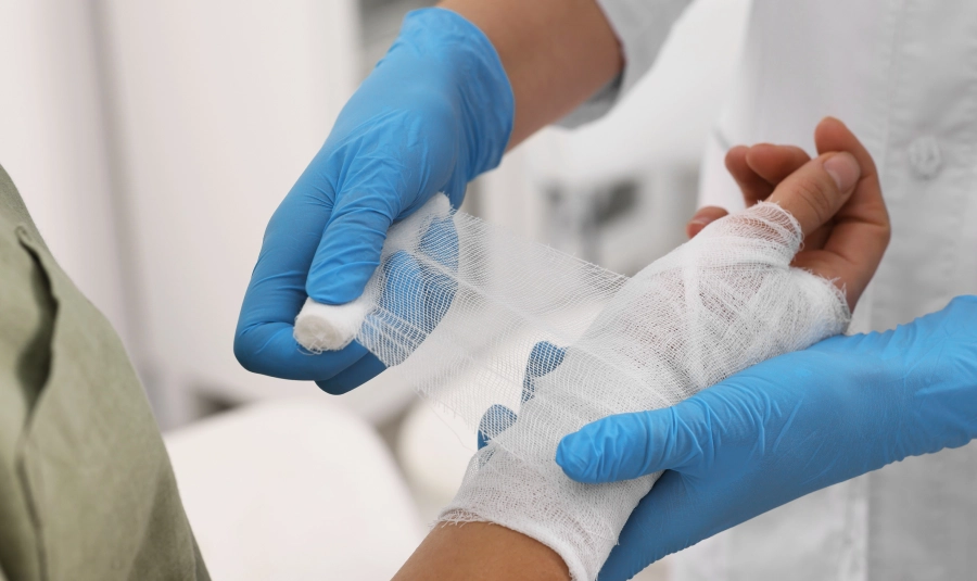 A medical professional wraps a patients wrist.