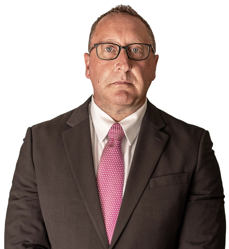 Chad Delventhal stands in a suit.