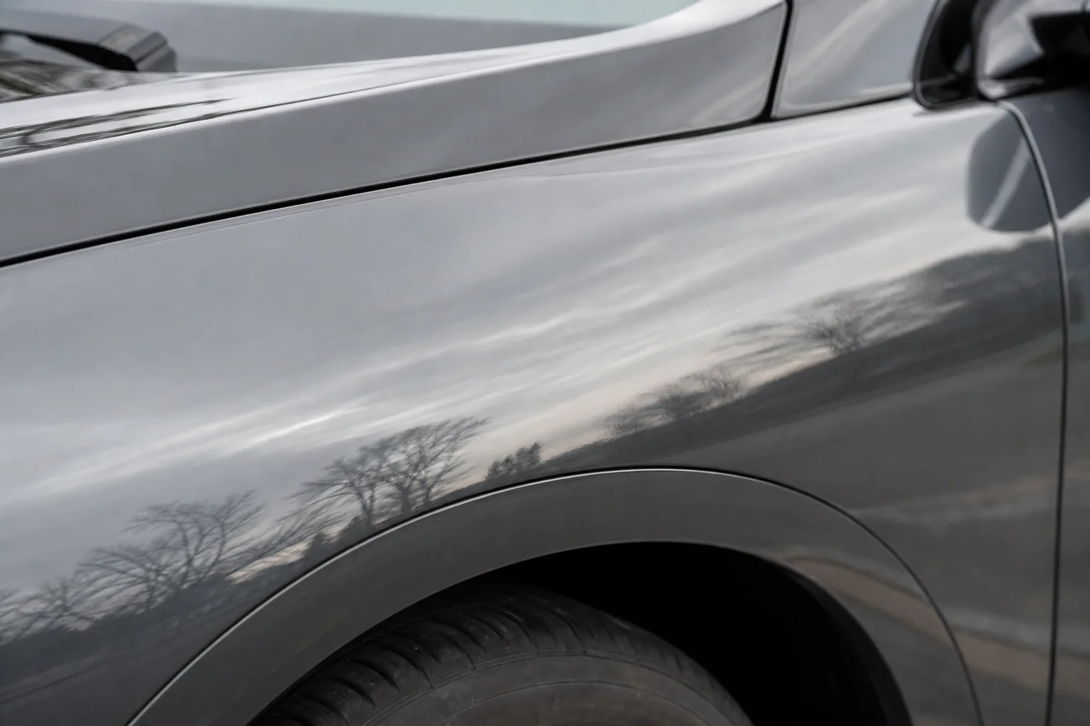 Close-up of a freshly repaired and repainted car fender after collision repair