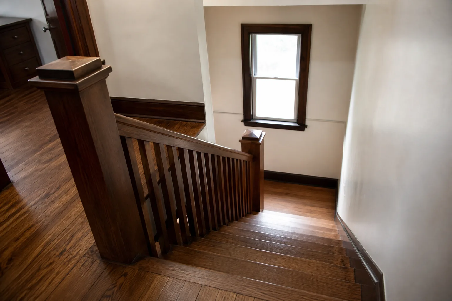 Wooden staircase and handrail inside an Indiana short-term rental