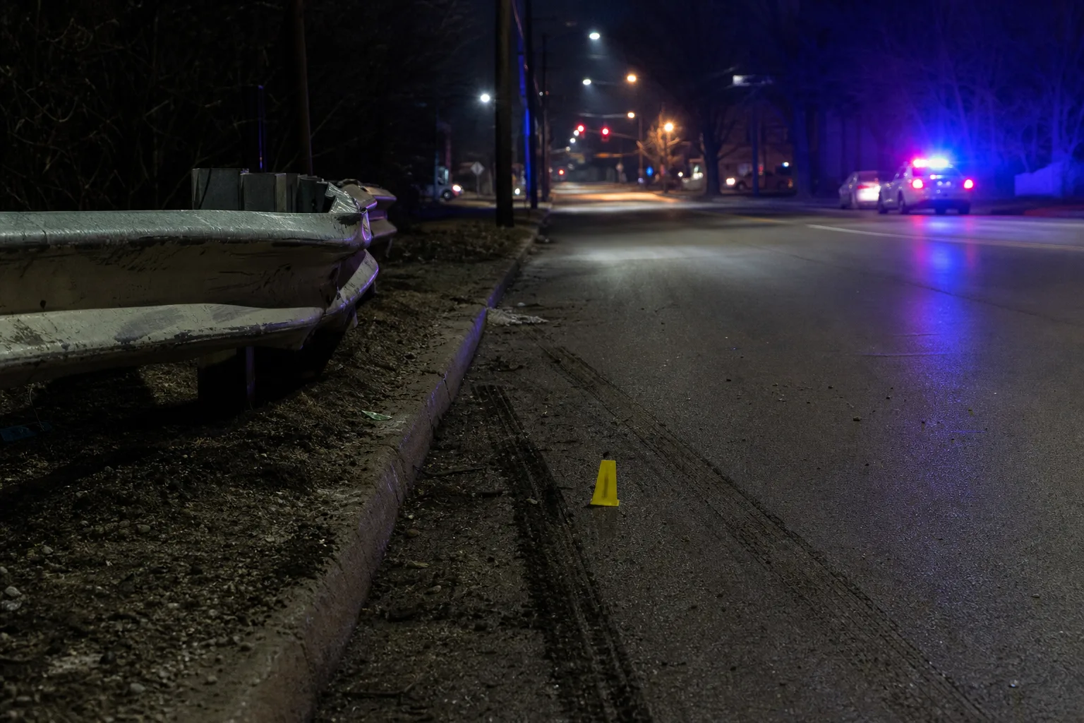 Roadside tire-mark and barrier evidence preserved after a nighttime Fort Wayne incident