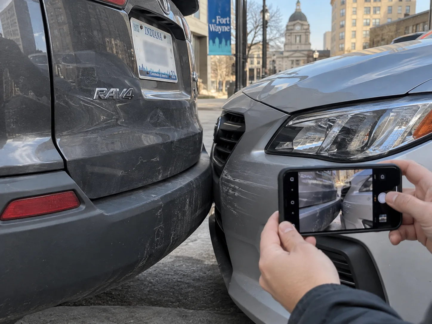 Vehicle contact areas being photographed after a Fort Wayne traffic collision