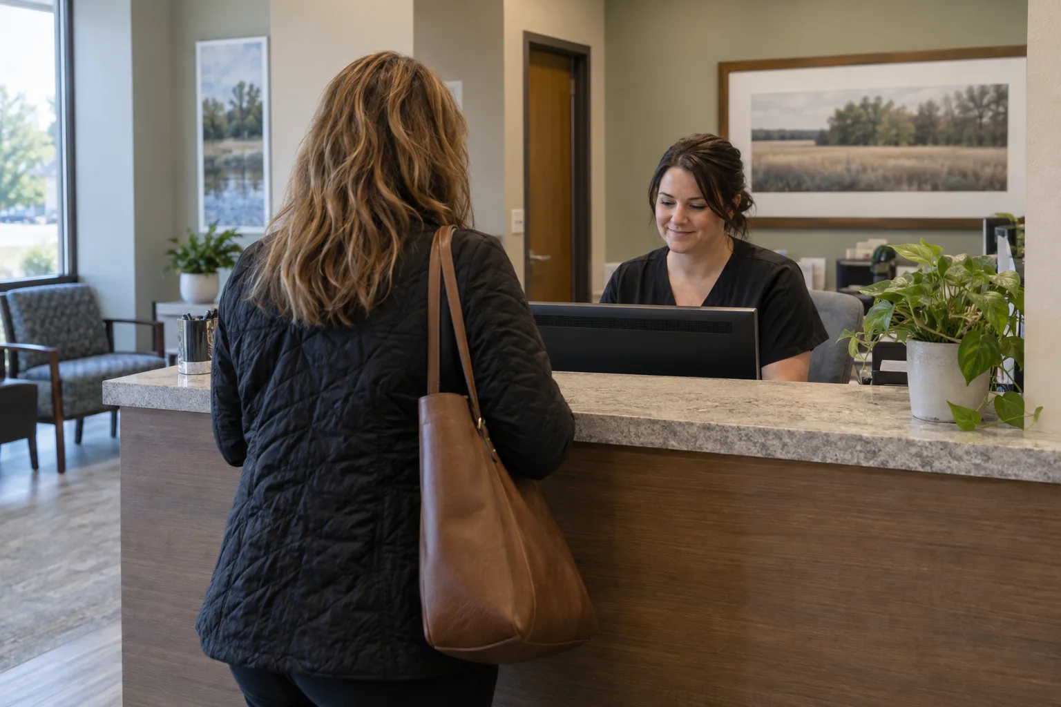 Patient checking in at a medical office front desk for an authorized appointment