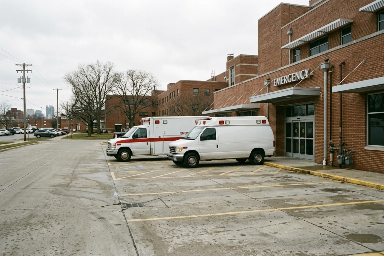 Two ambulances parked outside a hospital emergency entrance
