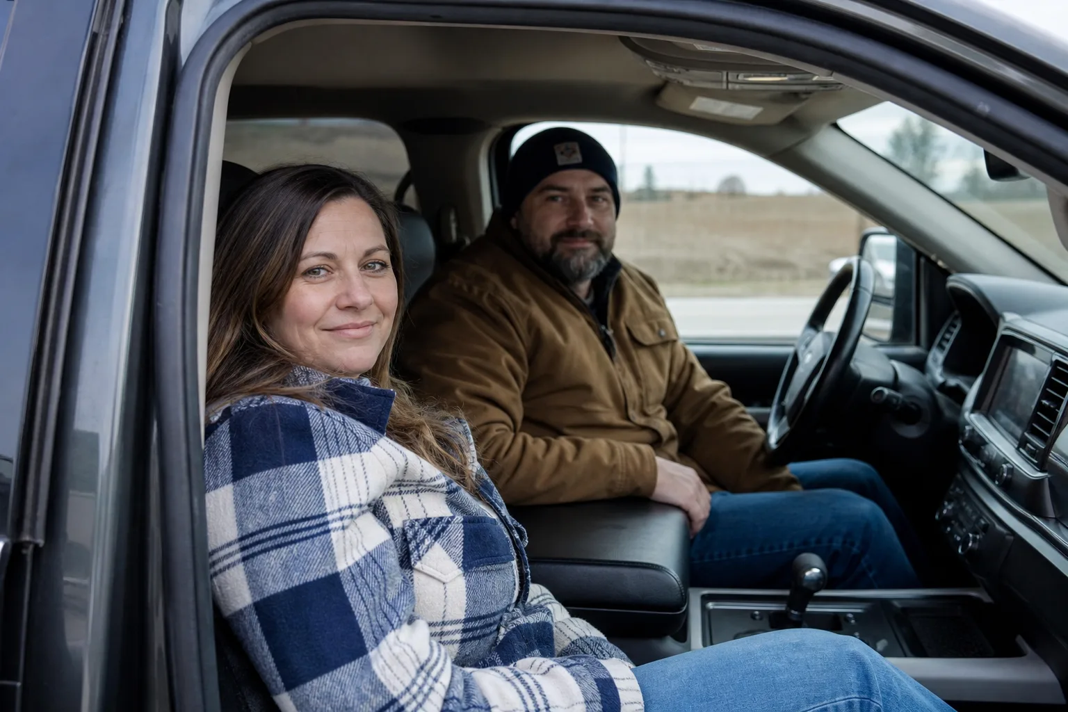 Driver and passenger seated in a safely parked car