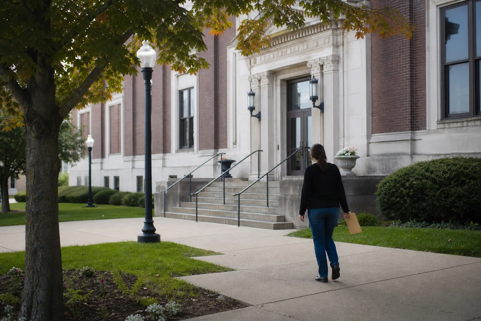 Person carrying documents toward a northeast Indiana courthouse