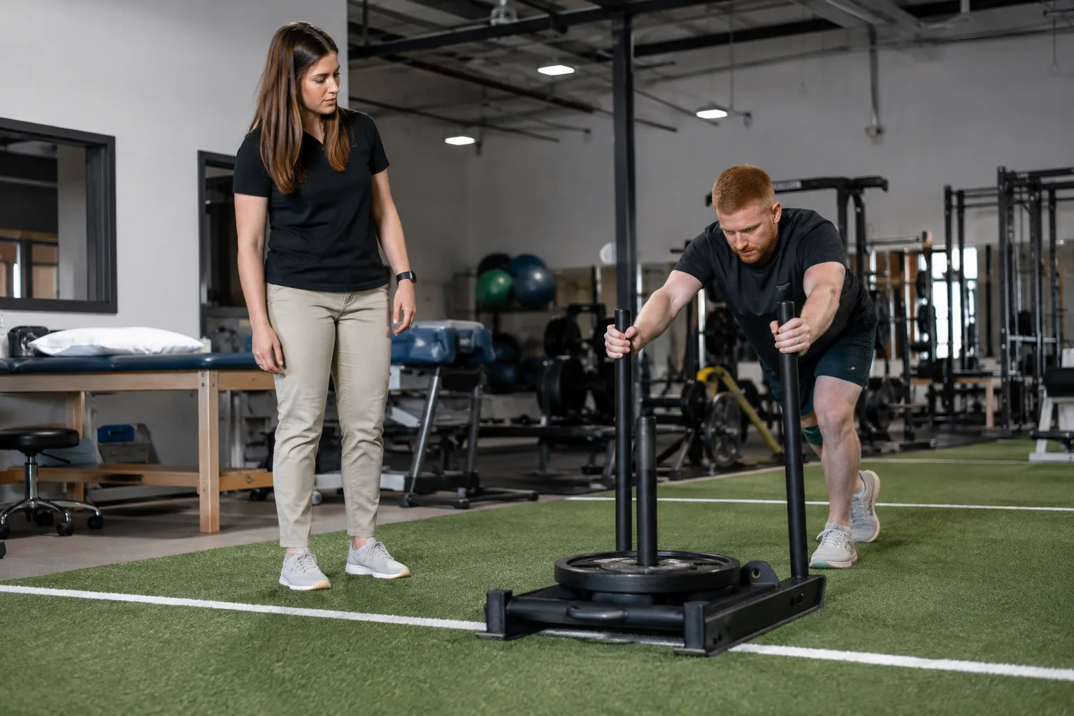 Worker performing a supervised pushing task during a capacity evaluation