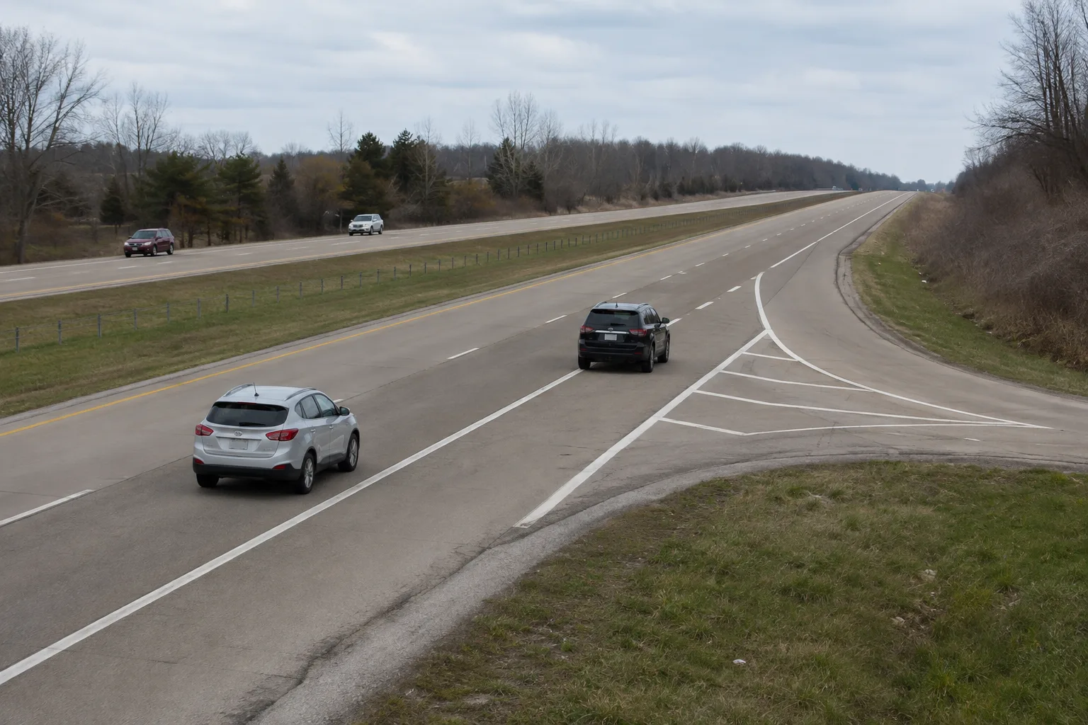 Vehicles approaching a marked highway merge in northeast Indiana