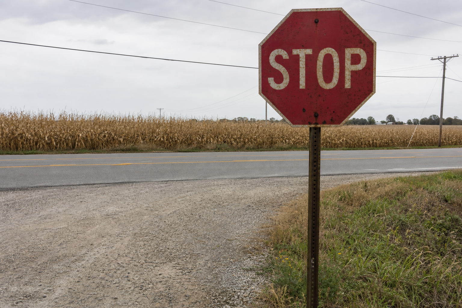 Weathered stop sign at a rural Steuben County intersection illustrating the right-of-way control common at crossings like SR 327 and CR 350 North.