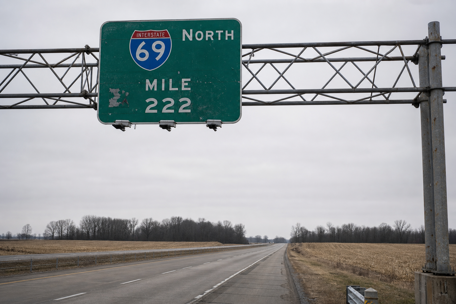 An overhead mile-marker sign on rural Interstate 69 in Huntington County, Indiana, near the location of the June 20, 2026 chain-reaction crash.