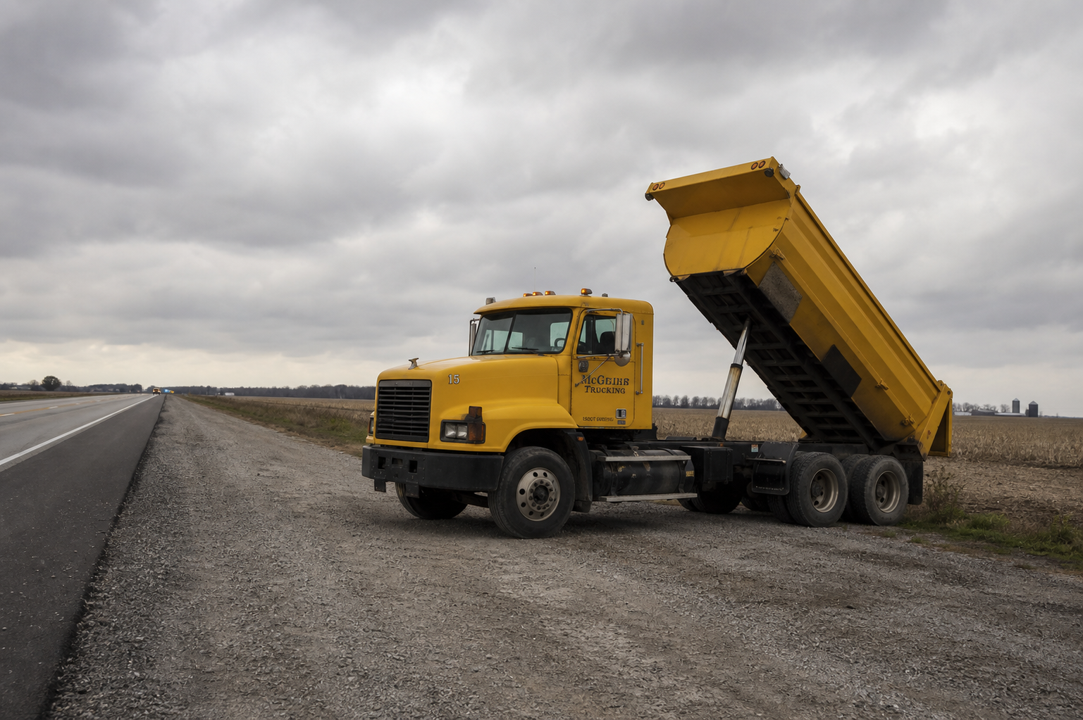 A commercial dump truck on the shoulder of a rural Indiana highway, the type of vehicle involved in the fatal failure-to-yield crash at State Road 1 and County Road 400 South in southwest Jay County on July 14, 2026