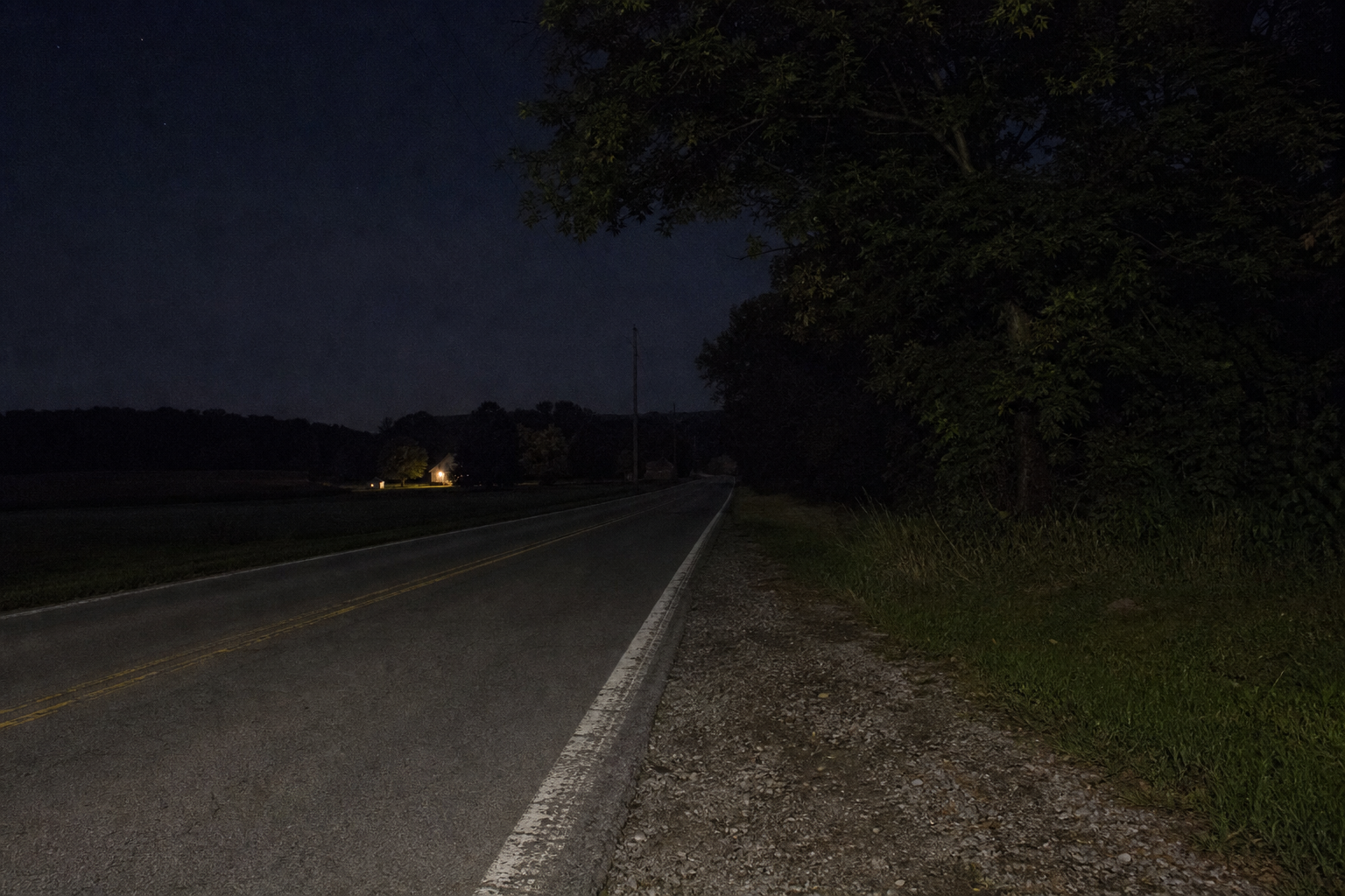 An empty rural county road in Jackson Township, Steuben County, Indiana at night, similar to the stretch of County Road 450 West where a late-night crash occurred