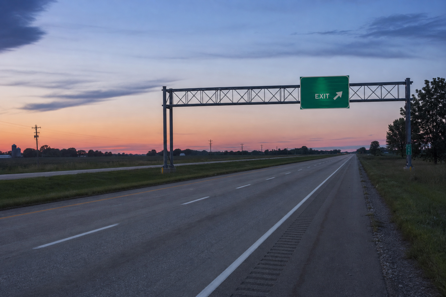 Empty westbound highway lanes near an interstate on-ramp sign in western Allen County, Indiana, similar to the site of a semi-truck and car crash on US-30