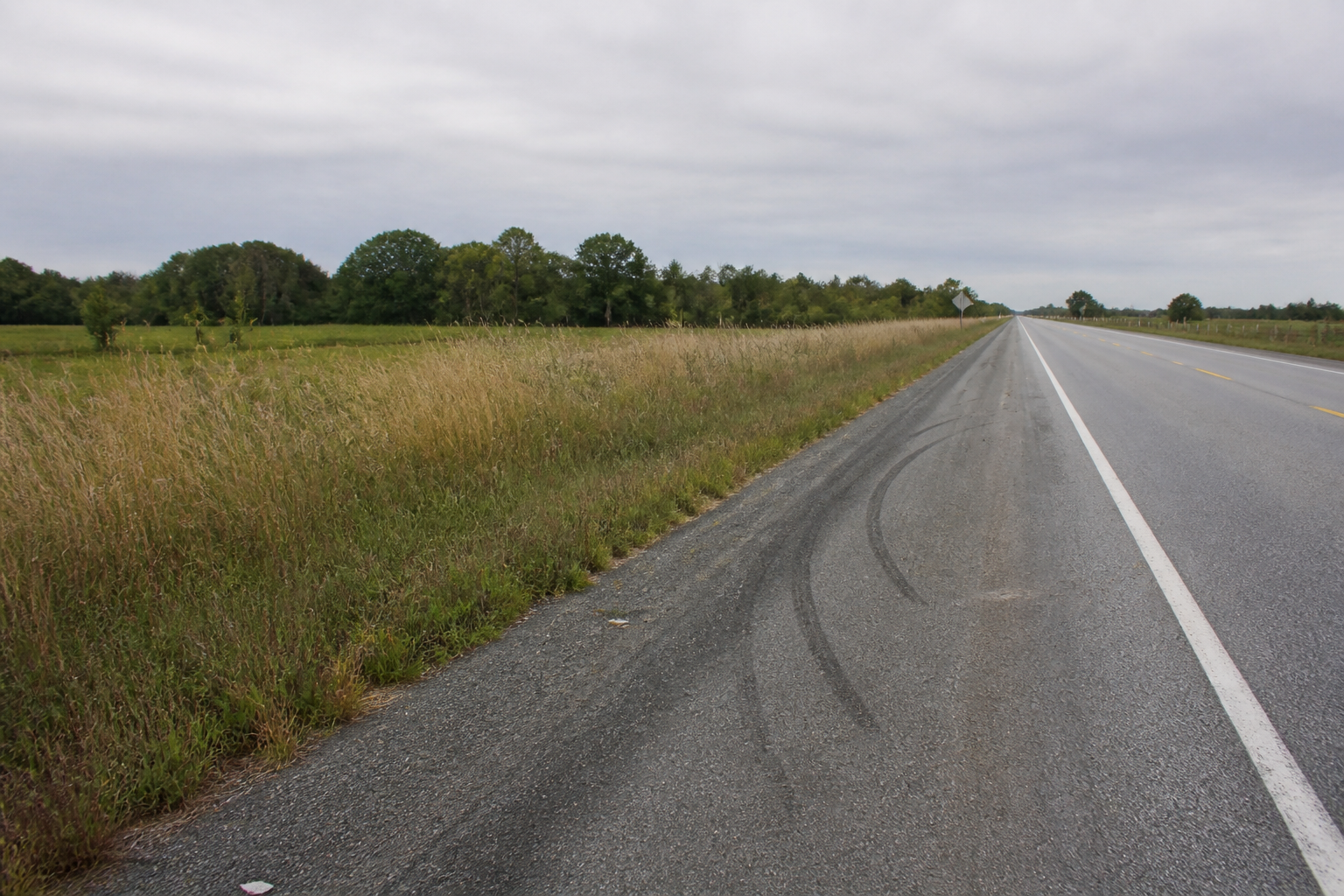 Empty highway shoulder in rural Cass County, Indiana near the site of a trailer jackknife crash on U.S. 35