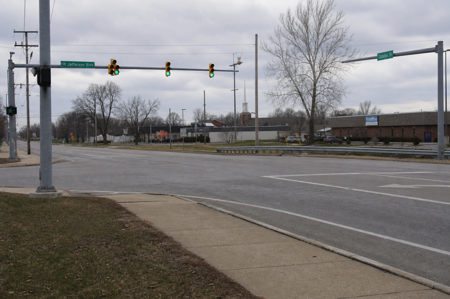 Roadway and guardrail near West Jefferson Boulevard and Catalpa Street in Fort Wayne, where police investigated a fatal motorcycle crash.