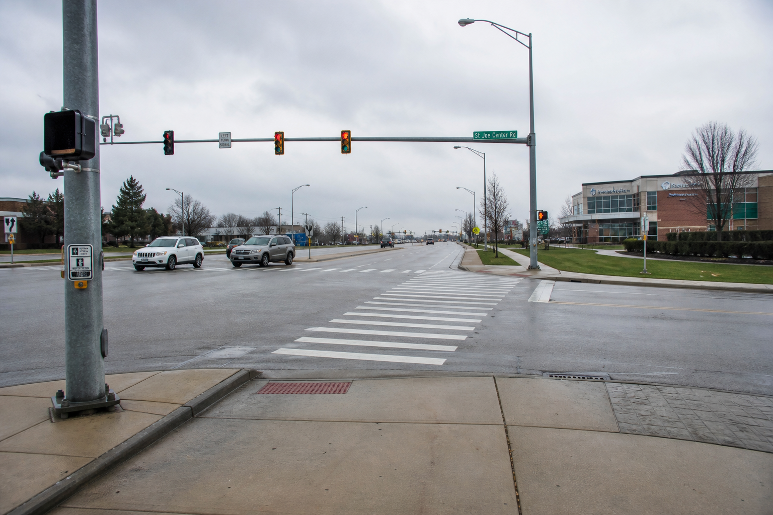 Crosswalk and traffic signals at a multi-lane Fort Wayne intersection, illustrating the roadway conditions relevant to the Coliseum Boulevard pedestrian collision.