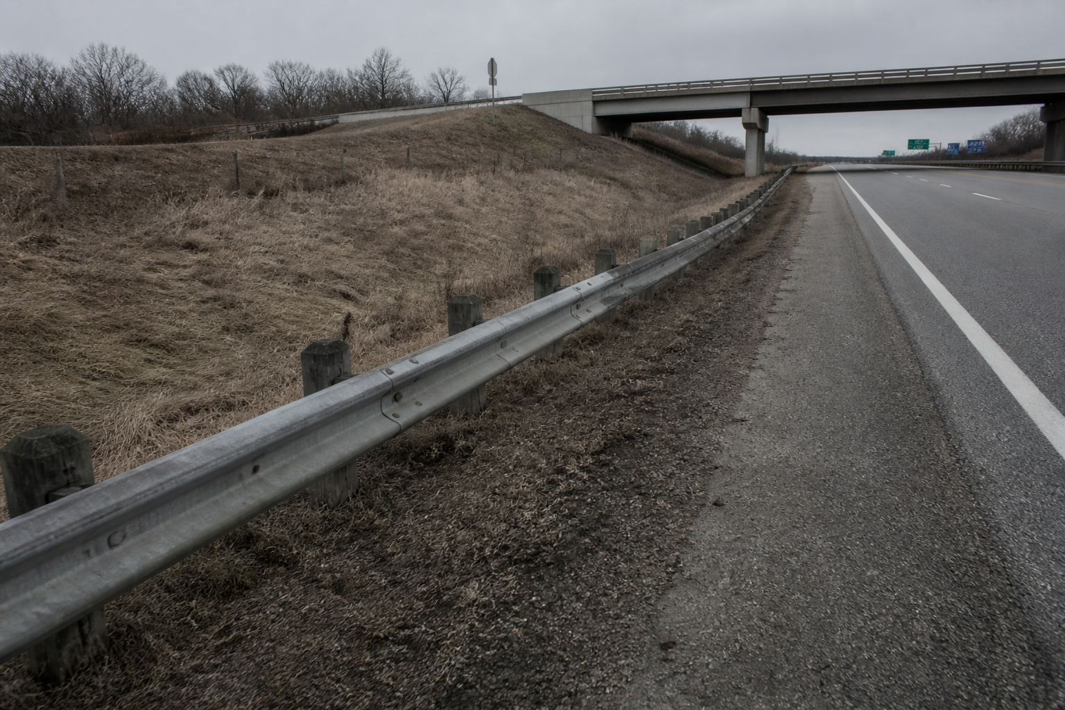 Interstate shoulder, guardrail, and overpass near the reported I-69 rollover location in DeKalb County.