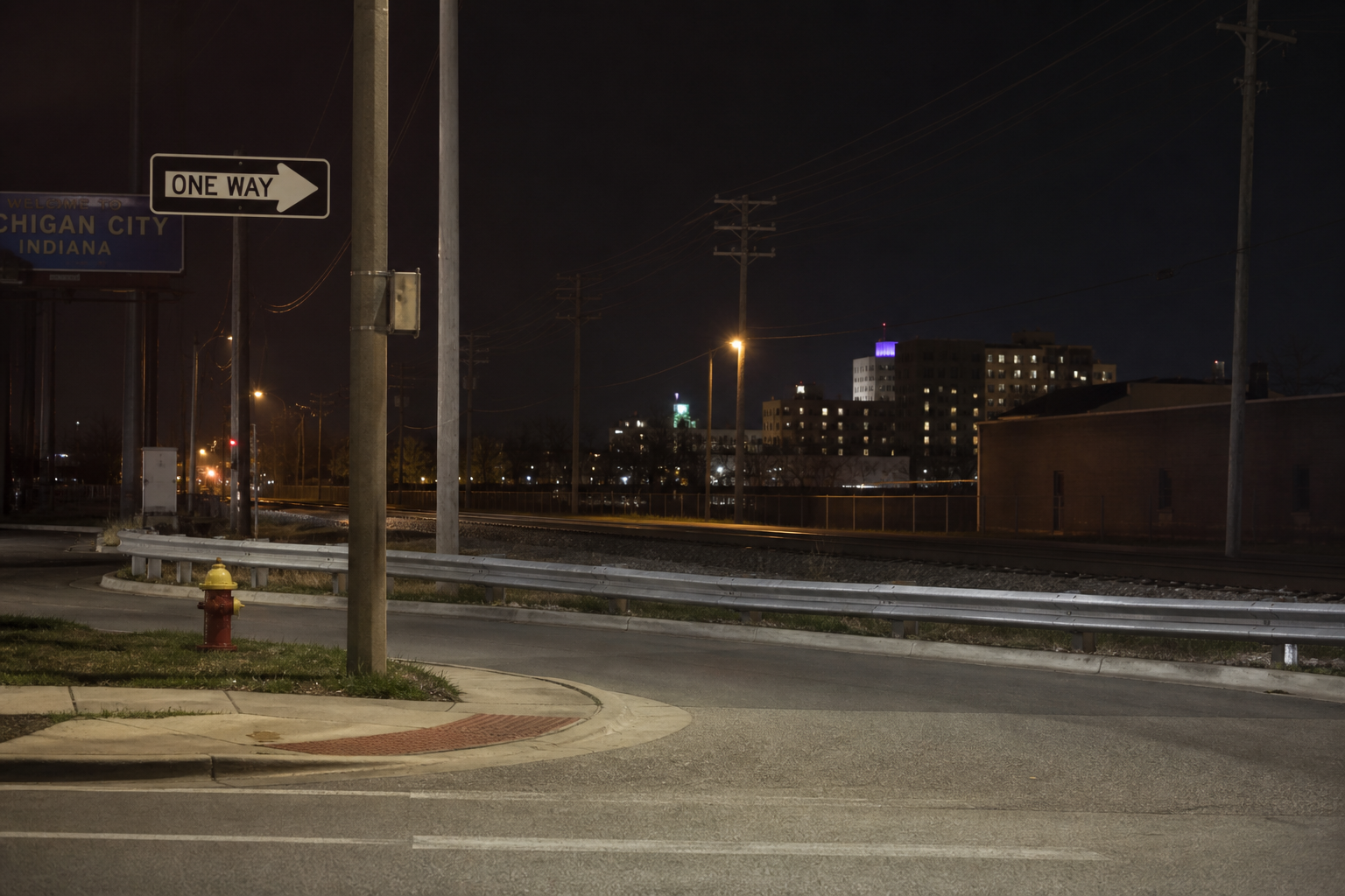 Nighttime streetscape near West 11th and Ohio streets in Michigan City, showing the one-way roadway setting relevant to the reported pursuit crash.
