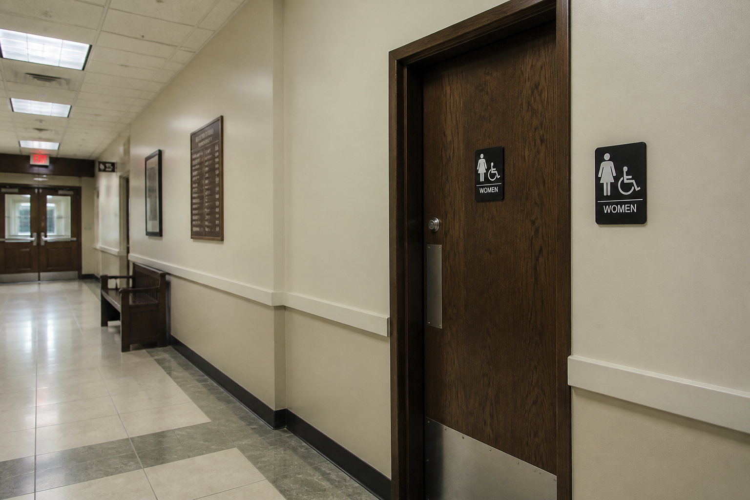 Generic municipal building hallway and restroom doorway illustrating the setting described in the Monticello workplace lawsuit.