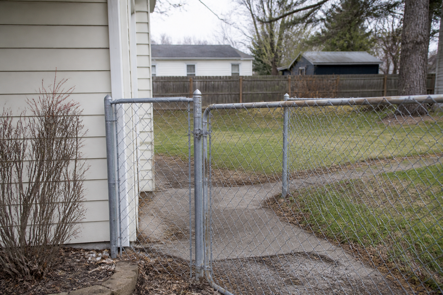A residential fence and gate illustrating location evidence that may matter after a dog bite in Greensburg, Indiana.