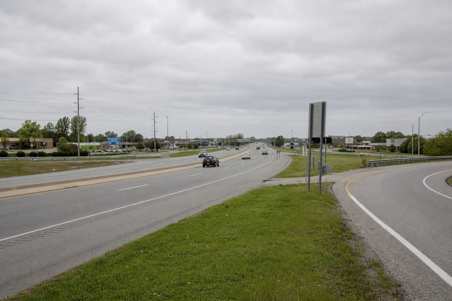 Divided highway and access-road turning area near U.S. 30 in Warsaw, relevant to the reported two vehicle crash.