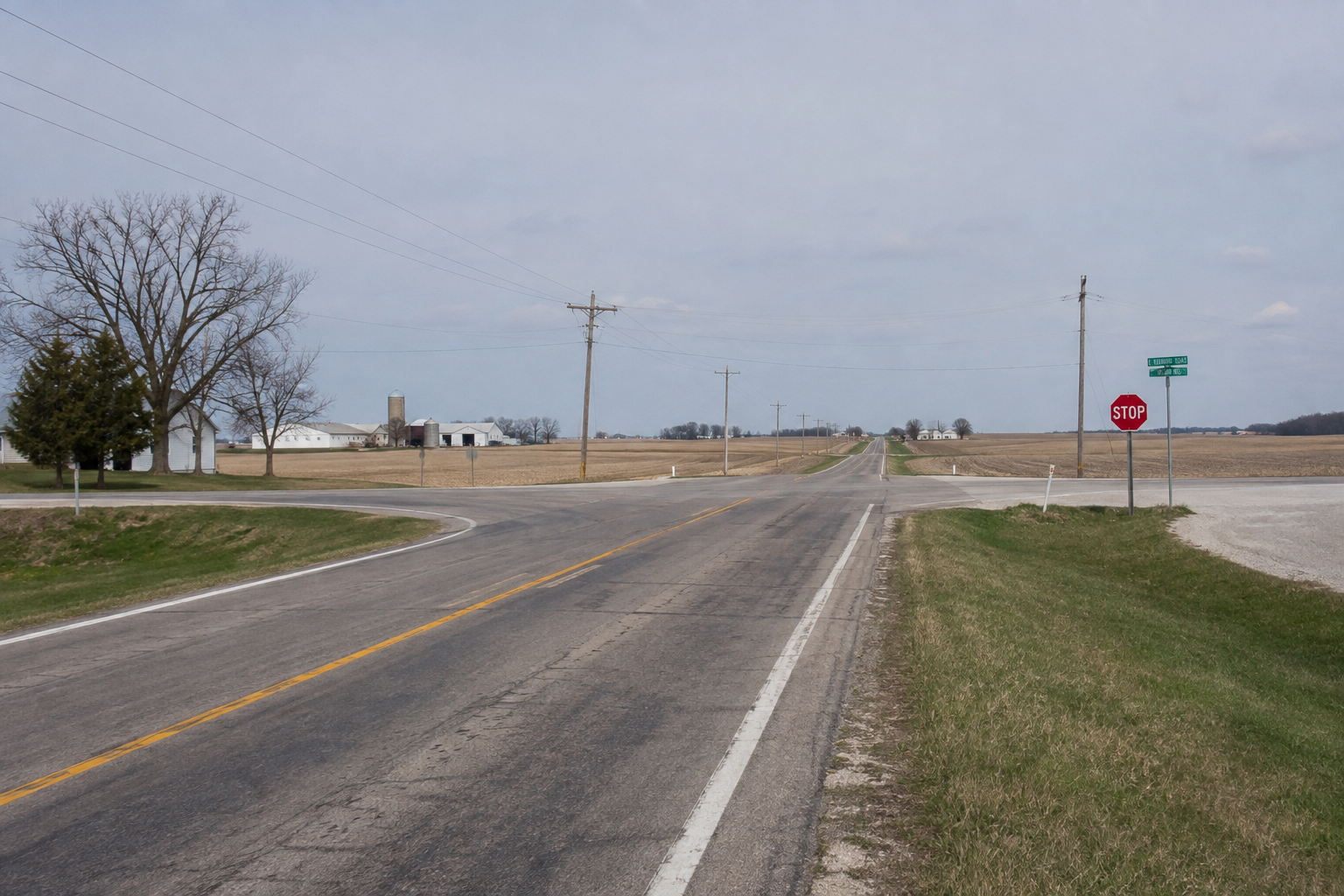 A rural two-lane highway junction in Parke County, illustrating the sight lines riders face near State Road 36 and Adams Road.
