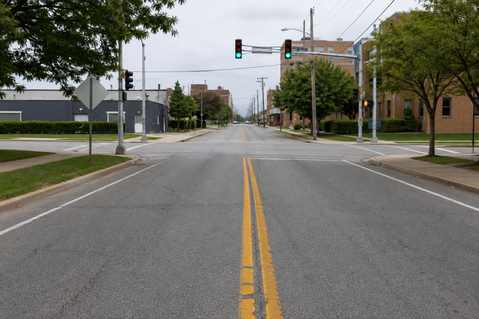 Double yellow centerlines at an Indianapolis intersection illustrate the no-passing roadway context of the fatal motorcycle crash.