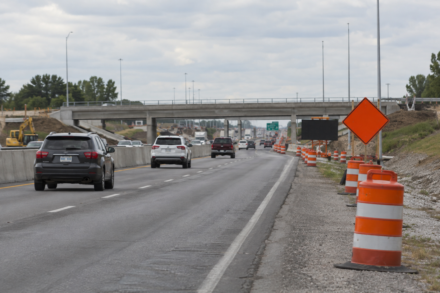 Traffic barrels and narrowed lanes in an Evansville expressway work zone illustrate the road conditions discussed after the Lloyd Expressway crash.