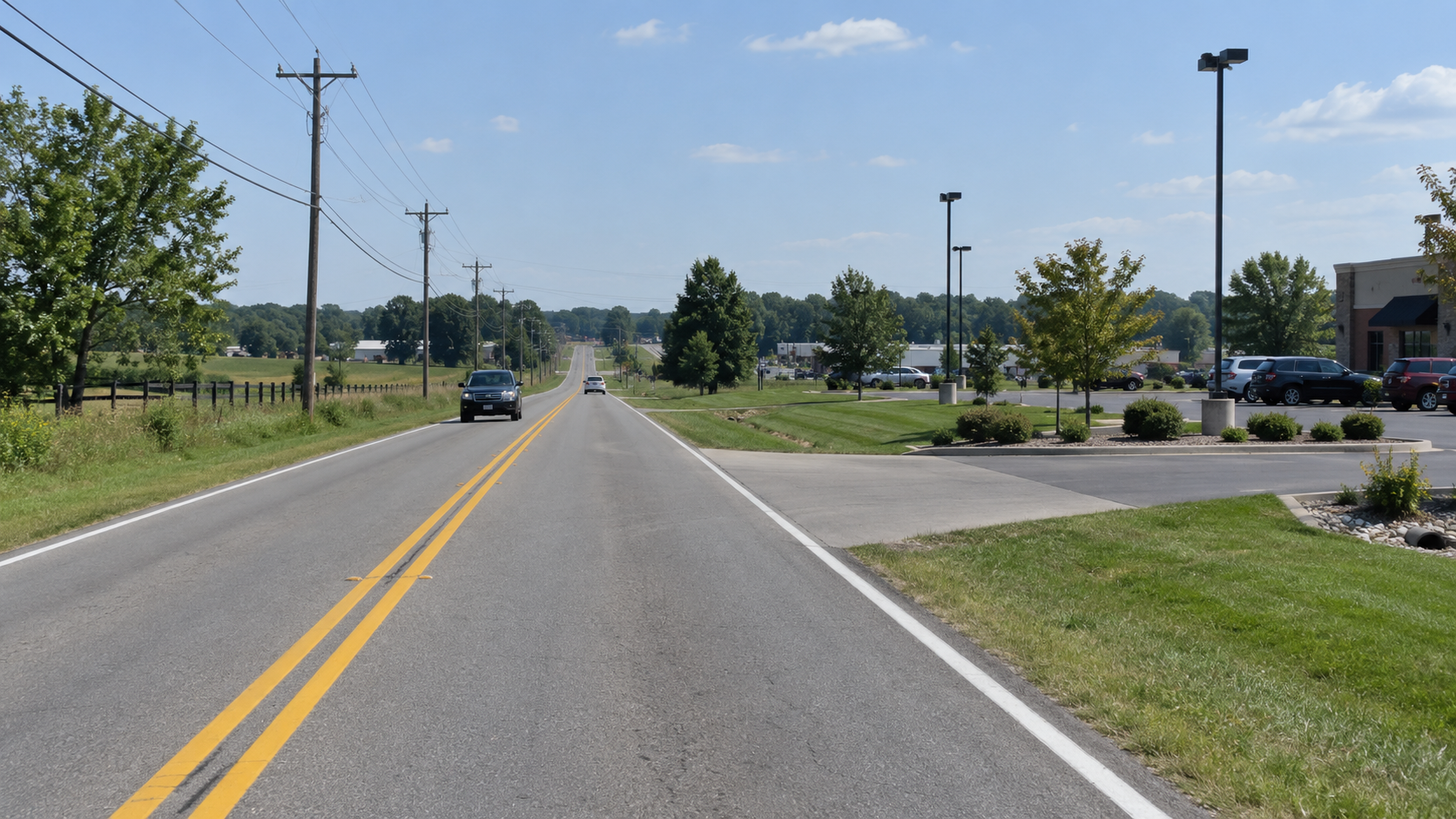 Parking-lot entrance along County Road 20 near Best Avenue in Elkhart County, illustrating the setting of the left-turn crash.