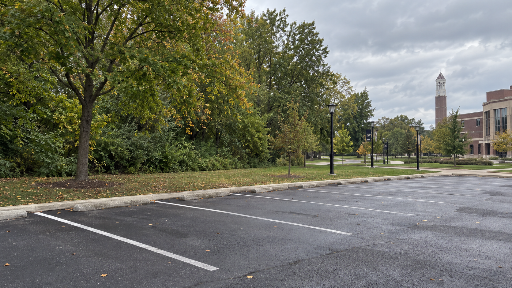 Parking area beside a tree line at a Lafayette, Indiana college campus, relevant to the reported shooting investigation.