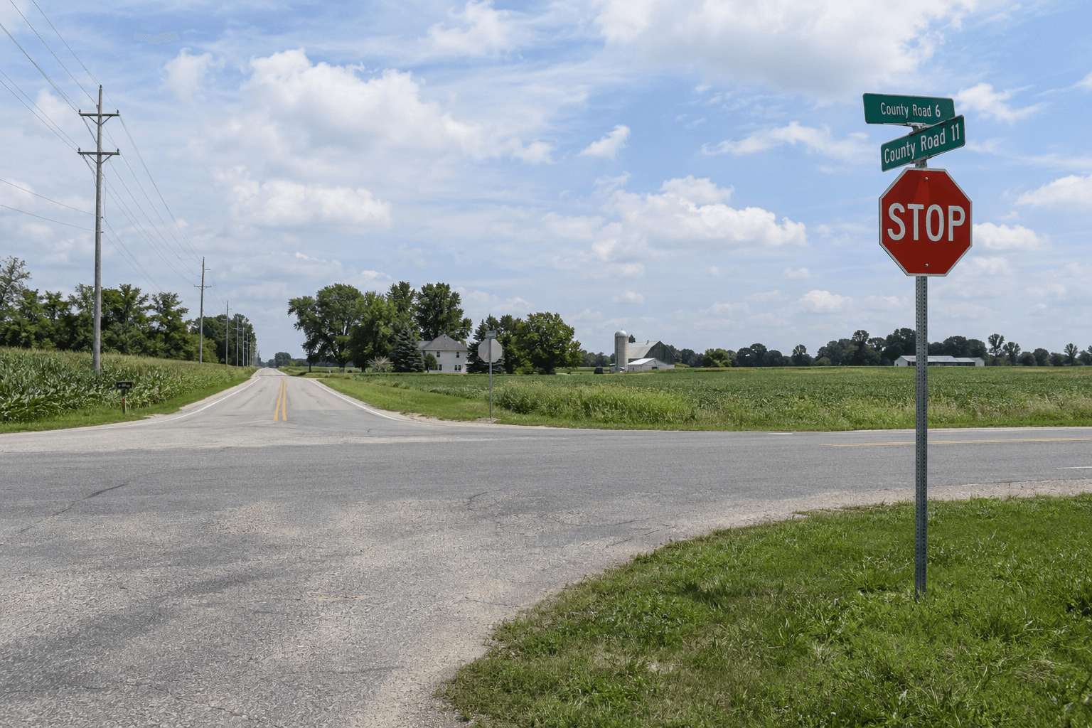 Stop-controlled rural intersection in Elkhart County, similar to the County Road 11 and County Road 30 crash location outside Goshen.