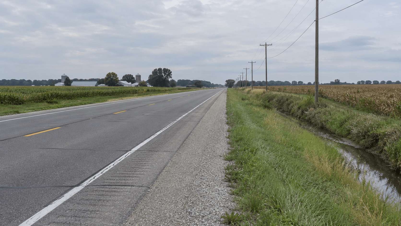 Roadside and embankment along State Road 8 in rural DeKalb County, where a pickup left the roadway.