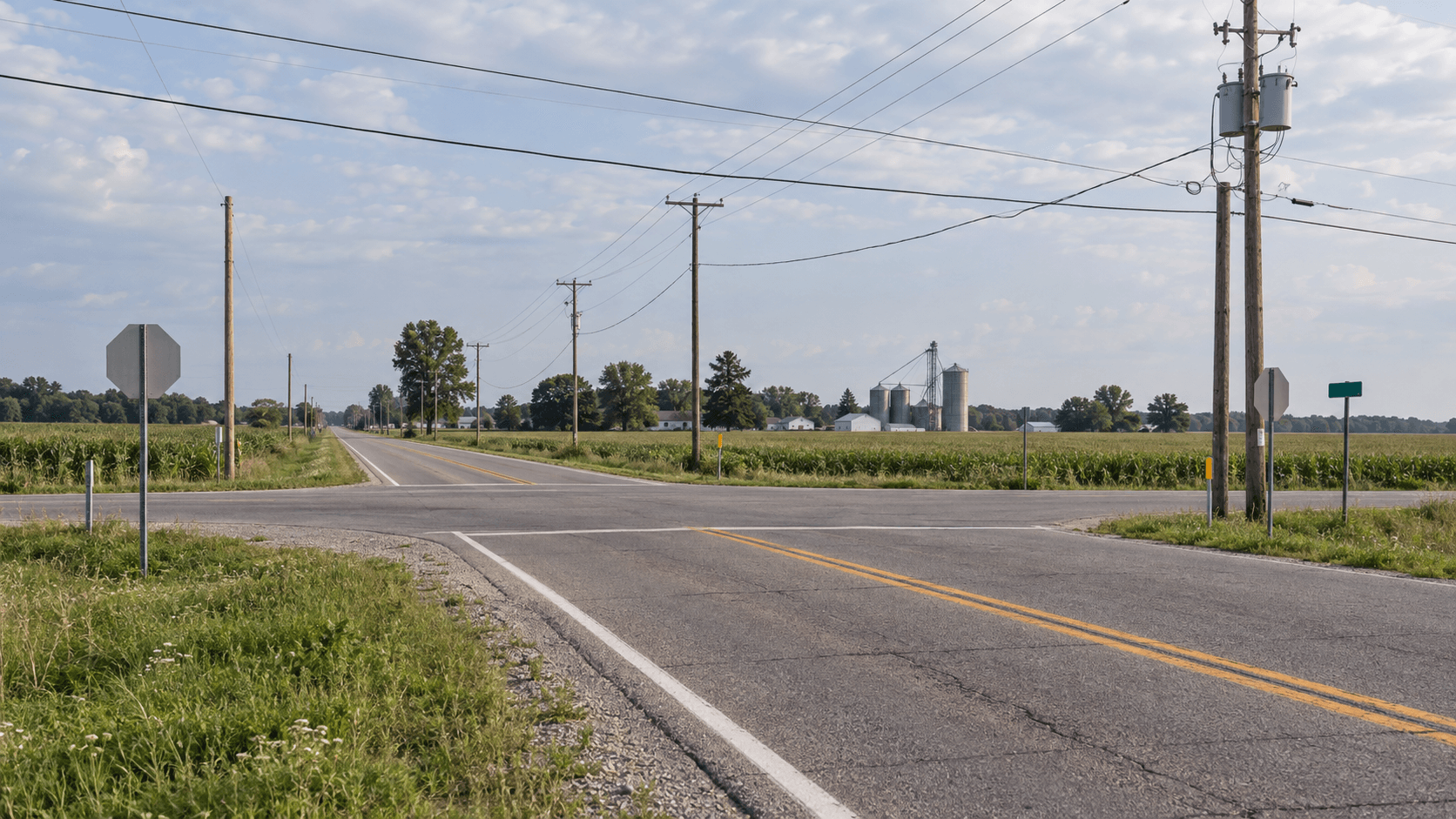 Roadside utility infrastructure near a state highway intersection in the Mentone area of Kosciusko County.