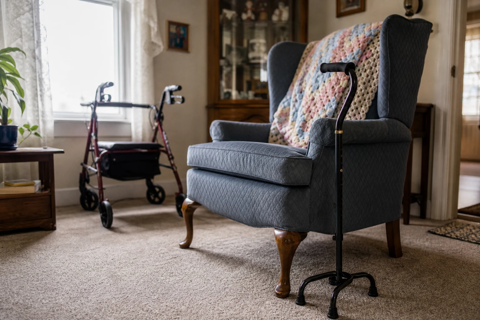 Fort Wayne living-room corner with a four-prong cane resting against a wingback chair, a folded rollator walker in soft focus, a hand-knit blanket — the daily mobility limitations a Fort Wayne disability attorney documents