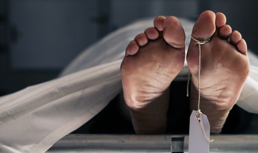 A name tag dangles from a deceased person's toes.